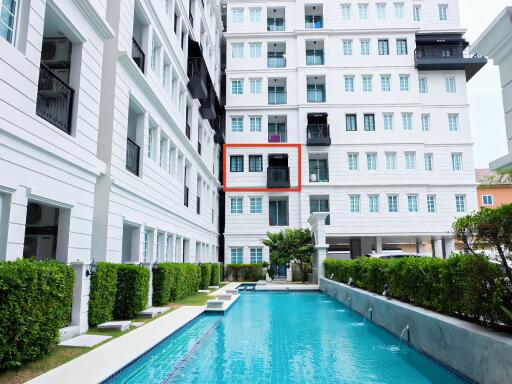 View of a residential building with a swimming pool