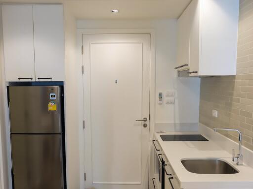 Modern kitchen with white cabinets and stainless steel appliances