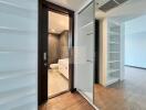 Modern bathroom with shower and white cabinetry, adjacent to living space