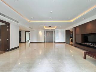 Spacious modern living room with glossy tile flooring and recessed lighting