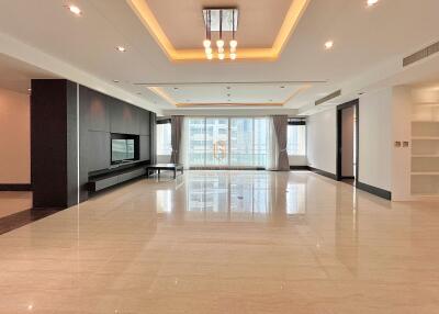 Spacious living room with modern lighting and large windows