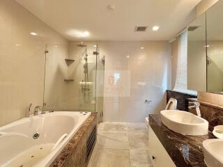 Modern bathroom with large tub and glass shower
