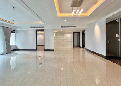 Spacious modern living area with recessed lighting and large windows