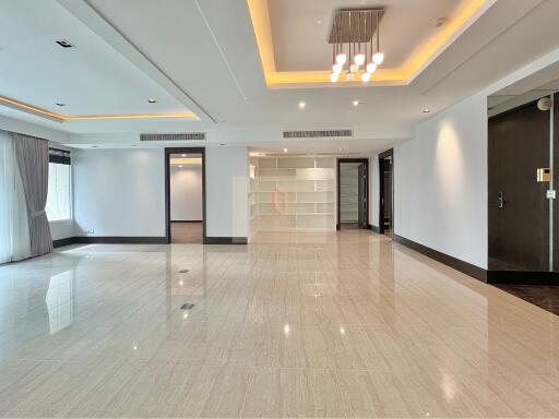 Spacious modern living area with recessed lighting and large windows