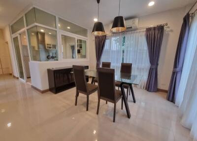 Modern dining room with glass table and four chairs