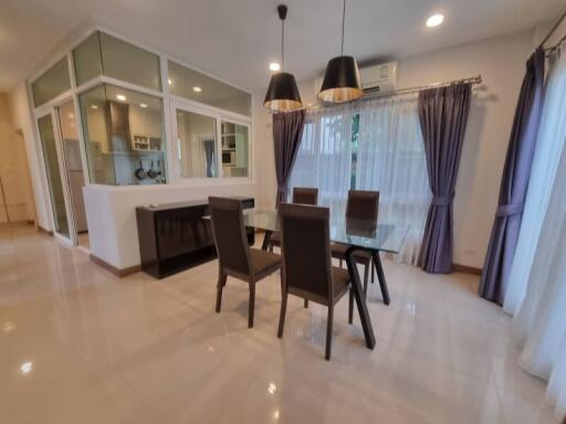 Modern dining room with glass table and four chairs