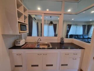 Modern kitchen with white cabinetry and a black countertop