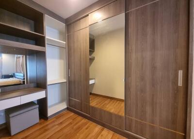 Modern bedroom with built-in wardrobe and wooden flooring