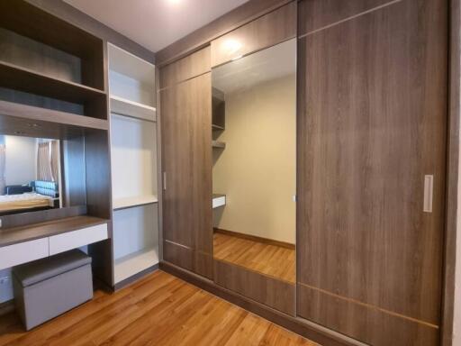 Modern bedroom with built-in wardrobe and wooden flooring