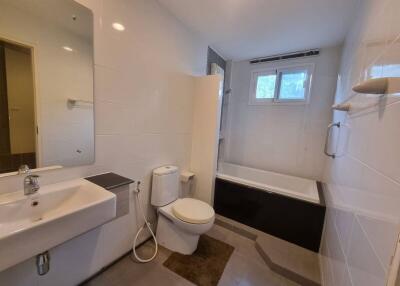 Modern bathroom with sink, toilet, and bathtub