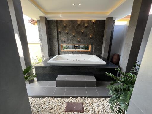 luxurious bathroom with a bathtub and decorative wall