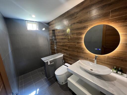 Modern bathroom with wooden accent wall and contemporary fixtures