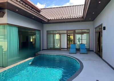 Outdoor pool area with seating and modern architectural design