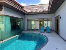 Outdoor pool area with seating and modern architectural design