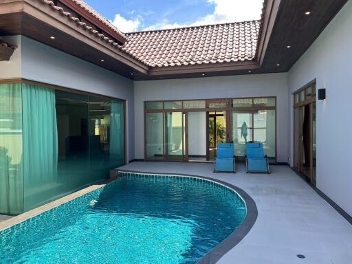 Outdoor pool area with seating and modern architectural design