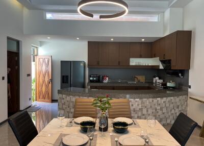 Modern kitchen and dining area with contemporary lighting