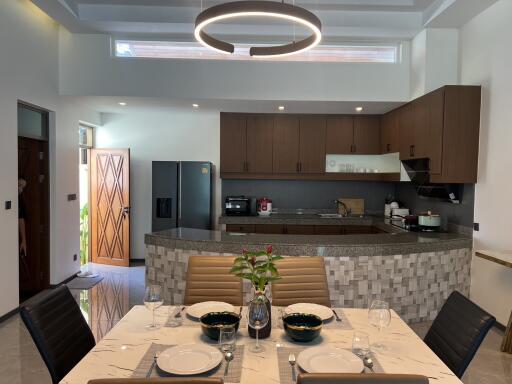 Modern kitchen and dining area with contemporary lighting