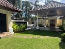 Well-maintained yard with a traditional-style open pavilion and lush greenery