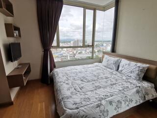 Bedroom with large window and city view