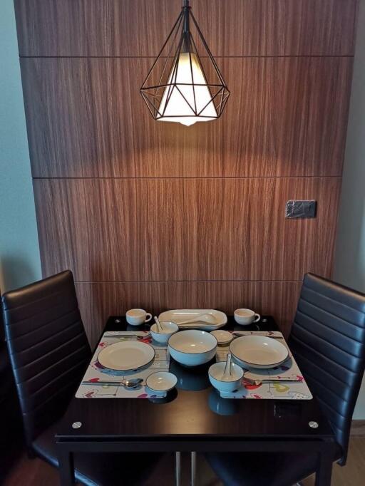 Cozy dining area with a modern chandelier and table setup