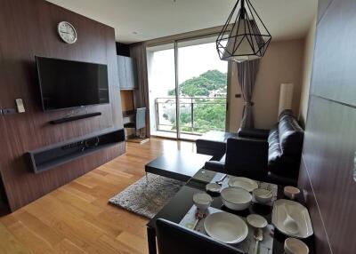 Modern living room with scenic view, leather furniture, and dining area