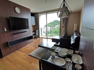 Modern living room with scenic view, leather furniture, and dining area