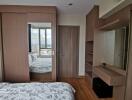 Modern bedroom with large window and built-in wardrobe