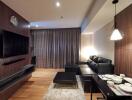 Modern living room with a black leather sofa and a flat-screen TV