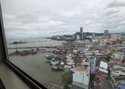 City and ocean view from high-rise building window