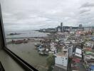 City and ocean view from high-rise building window