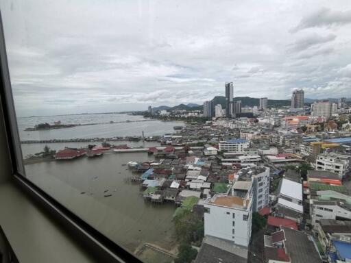 City and ocean view from high-rise building window