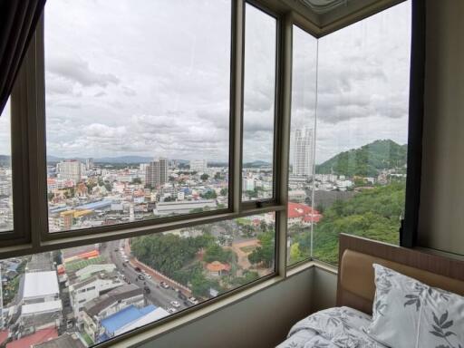 Bright and cozy bedroom with a city view