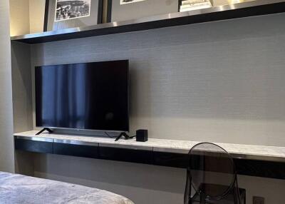 Modern bedroom with TV and wall decor