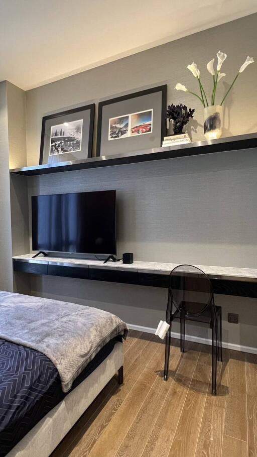 Modern bedroom with TV and wall decor