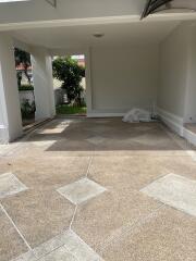 Covered garage space with a view of the garden