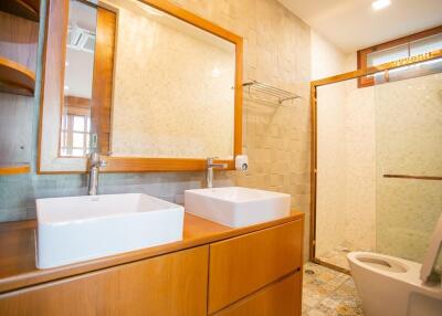 Modern bathroom with wooden cabinets and double sink