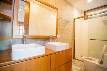 Modern bathroom with wooden cabinets and double sink