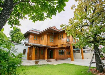 Exterior view of a wooden house with a green lawn