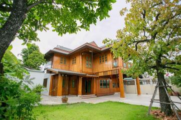 Exterior view of a wooden house with a green lawn