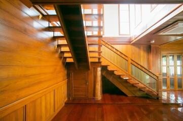 Wooden staircase in a well-lit hallway