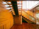 Wooden staircase in a well-lit hallway