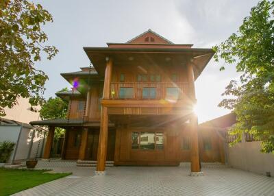 exterior view of a house with wooden facade and lush greenery