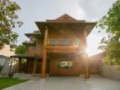 exterior view of a house with wooden facade and lush greenery