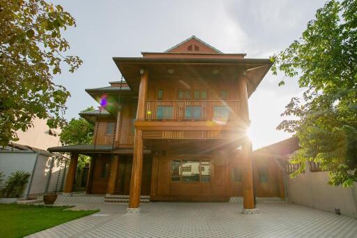 exterior view of a house with wooden facade and lush greenery