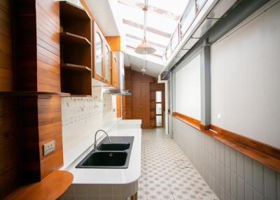 Bright, modern kitchen with wooden cabinets and two sinks