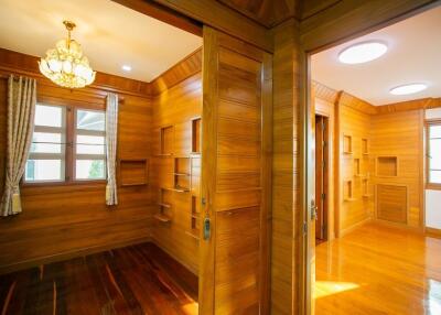 Wood-paneled rooms with large windows and built-in shelving