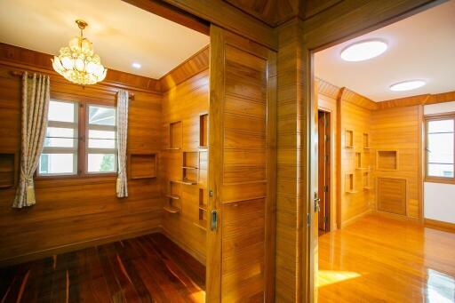 Wood-paneled rooms with large windows and built-in shelving