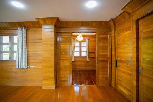 Spacious wooden bedroom with natural lighting