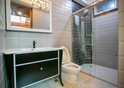 Modern bathroom with glass shower and large vanity mirror