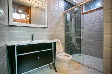 Modern bathroom with glass shower and large vanity mirror